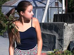 Gorgeous brunette is pissing in the garden